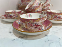 Load image into Gallery viewer, A set of twelve Minton's pink cockatrice teacups and saucers. Circa 1912-1950