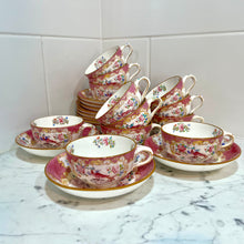Load image into Gallery viewer, A set of twelve Minton's pink cockatrice teacups and saucers. Circa 1912-1950