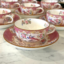 Load image into Gallery viewer, A set of twelve Minton's pink cockatrice teacups and saucers. Circa 1912-1950