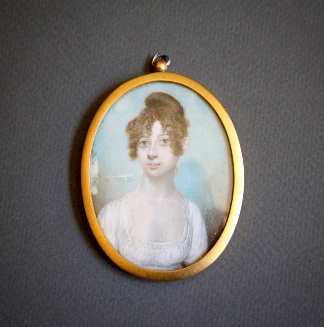 A Georgian oval portrait miniature of a young lady. English School circa 1805