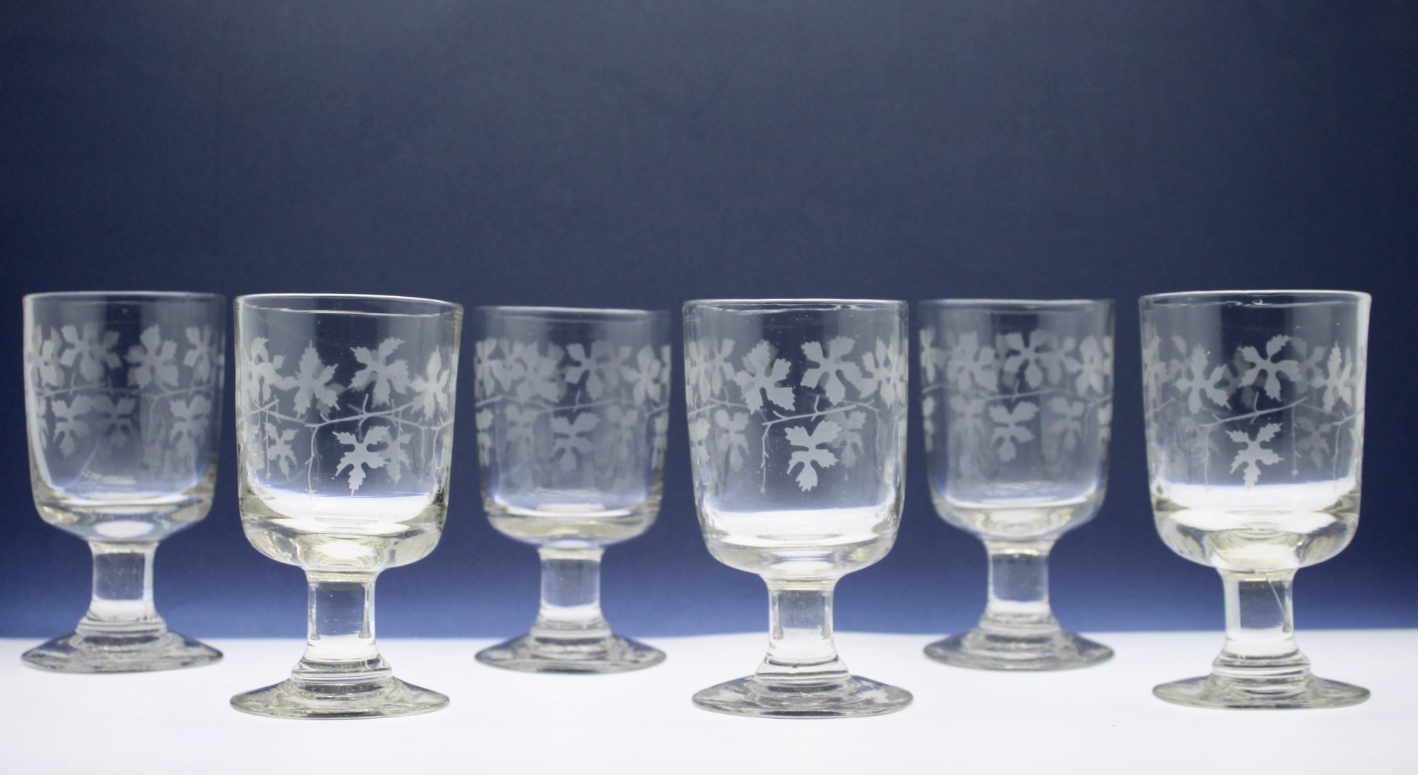 A rare set of six 19th century glasses with etched vine leaf decoration.  Circa 1850