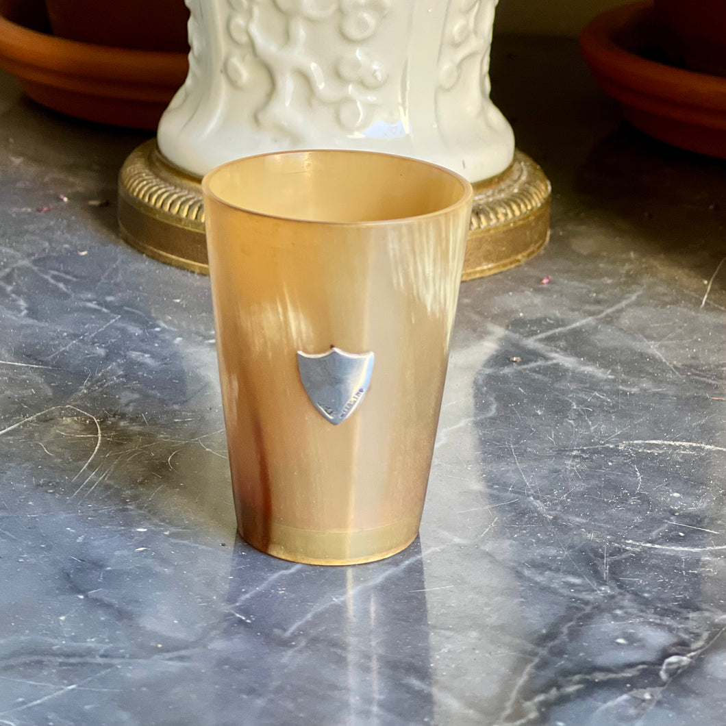 A small blonde horn beaker with sterling silver shield. 19th century