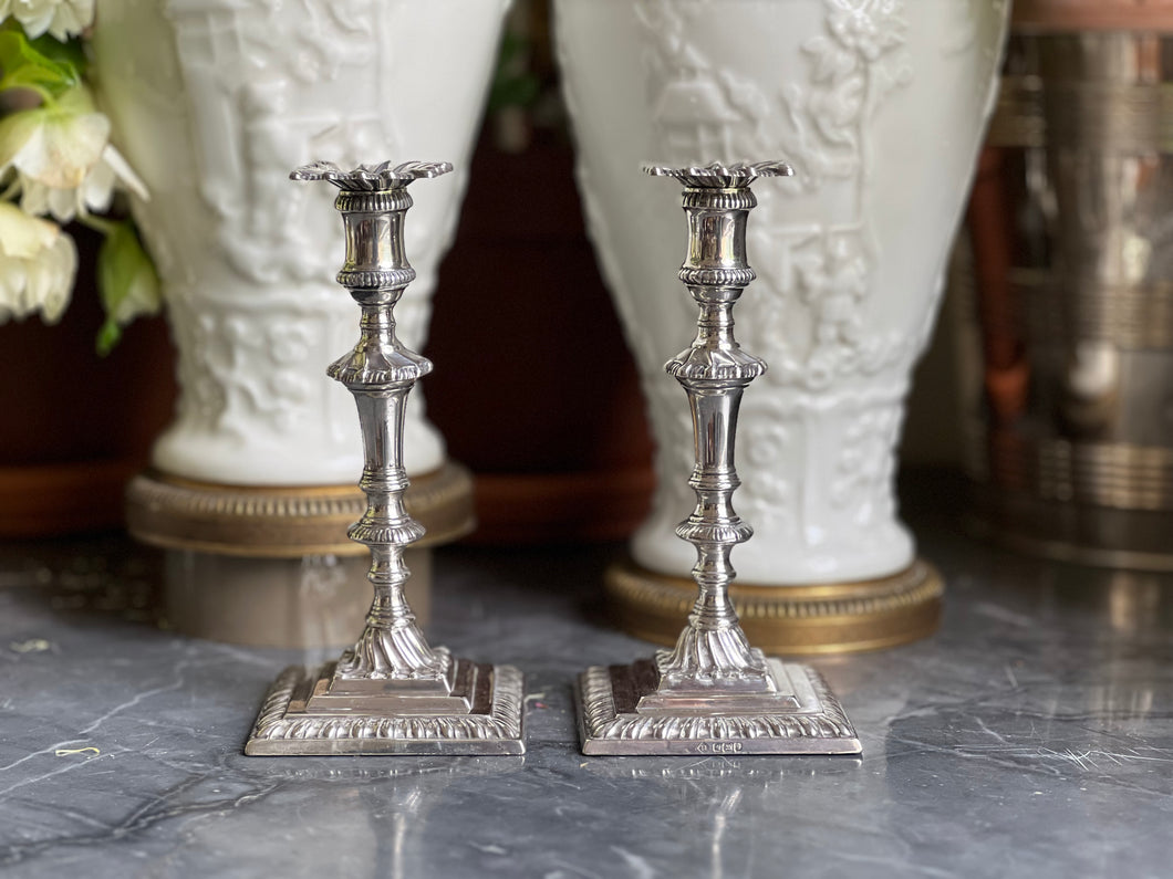 A pair of early George III style sterling silver tapersticks. Sheffield 1910