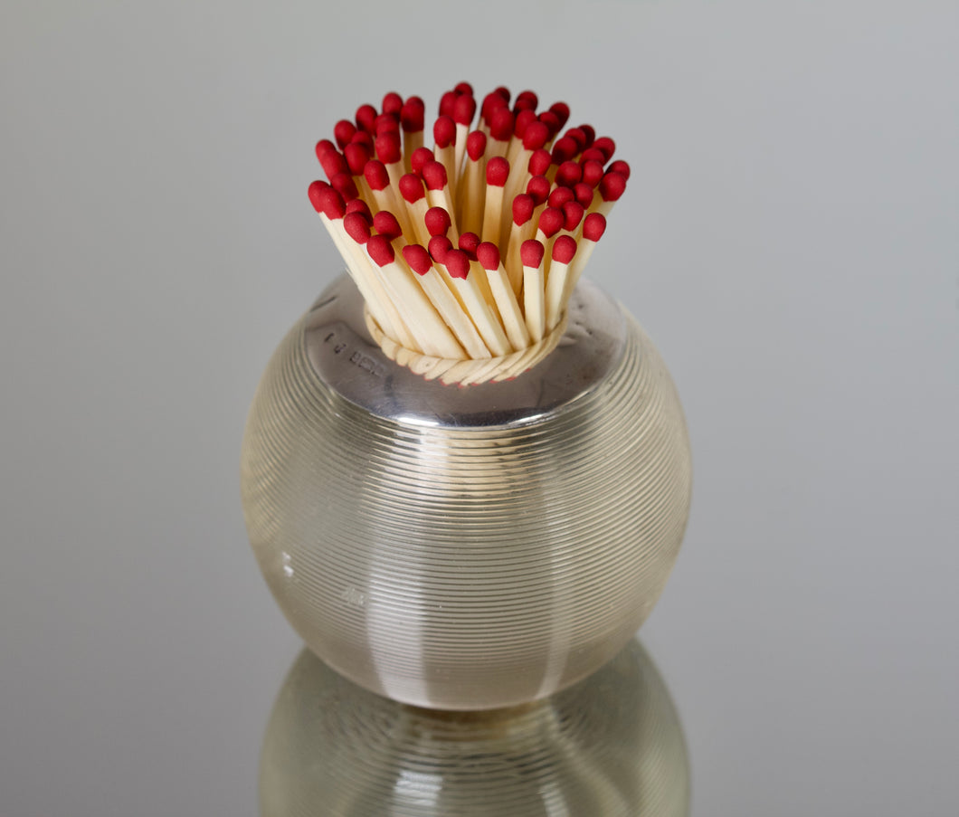 An Edwardian ribbed glass match striker with sterling silver mount and interior. London 1914